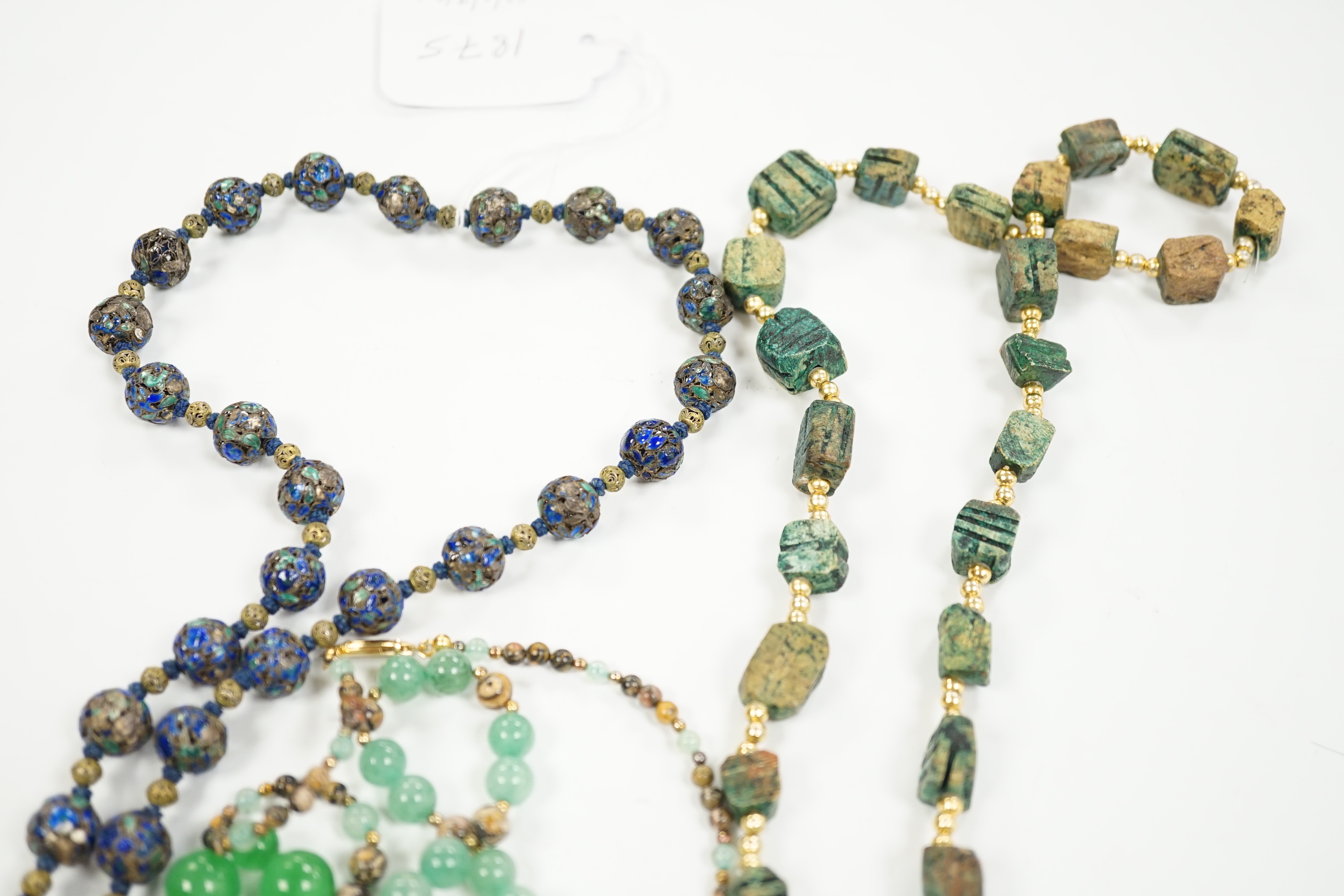 Three assorted Chinese bead necklaces including filigree gilt white metal and enamel pendant necklace, overall 68cm and a jade bracelet.